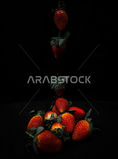 A plate of delicious strawberry fruit, black background, fresh fruits, strawberry fruits from the farms of the Kingdom of Saudi Arabia