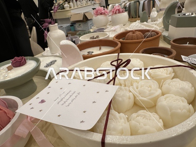 Handmade candles in the shape of flowers at the Ramadan Souk event at Al-Qusaybi Hotel in the Eastern Province, a traditional Ramadan event that brings together the atmosphere of the holy month, popular shops, local products, Ramadan foods, handicrafts, and traditional gifts, in a warm cultural and social experience that reflects the spirit of Ramadan and Saudi authenticity within a luxurious hotel setting.