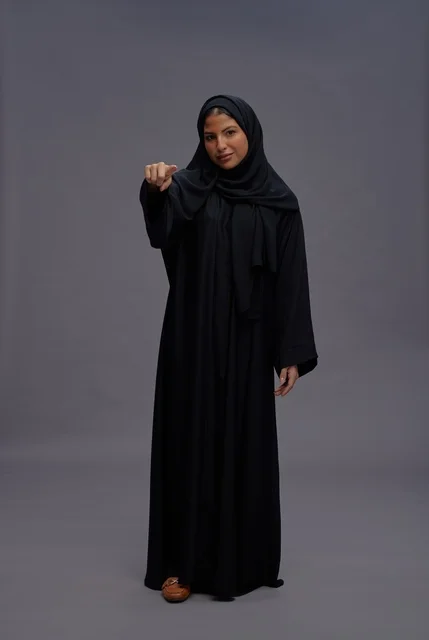Saudi Woman in Black Abaya Pointing at Camera