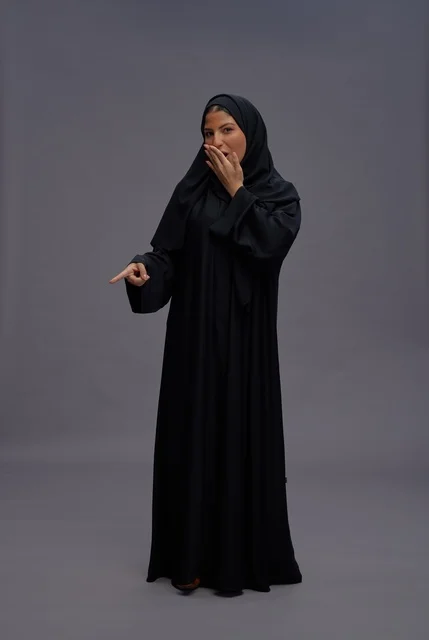 Surprised Saudi Woman in Traditional Black Abaya