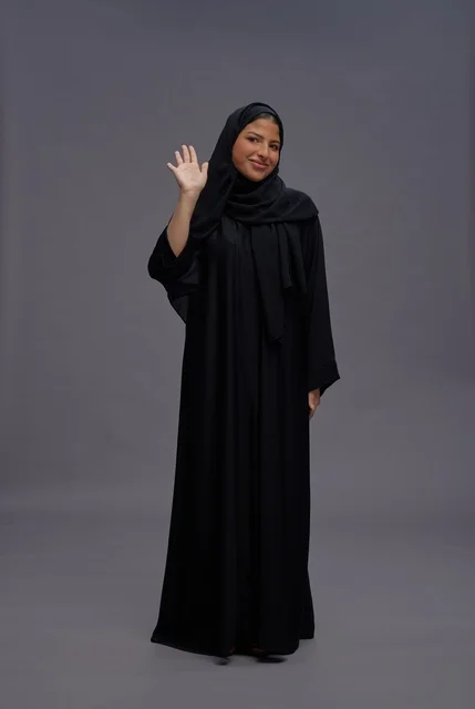 Saudi Woman in Black Abaya Waving on Grey Background