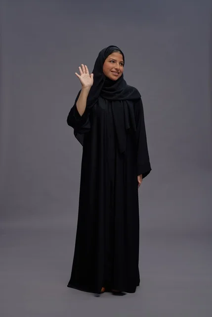 Saudi Woman in Black Abaya Waving on Grey Background