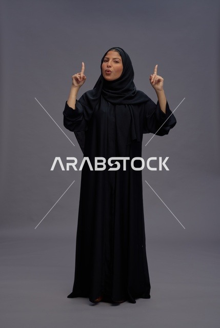 Saudi Woman in Traditional Abaya Pointing Upwards