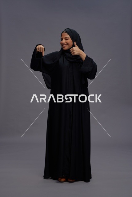 Saudi Woman in Traditional Abaya with Thumbs Up Gesture
