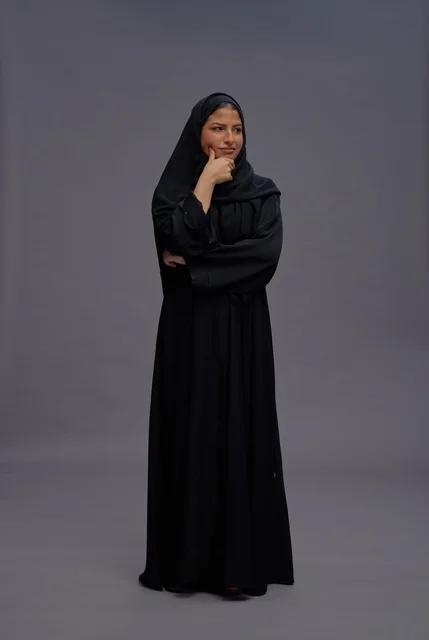 Saudi Woman in Traditional Abaya Standing in Studio