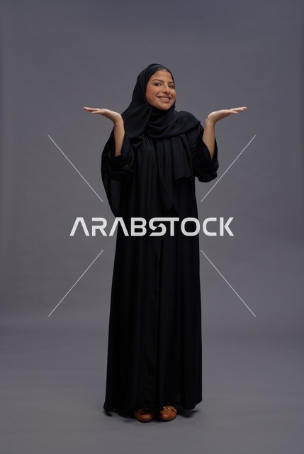 Saudi Woman Gesturing in Traditional Black Abaya