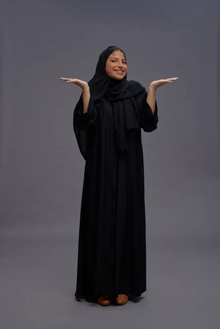 Saudi Woman Gesturing in Traditional Black Abaya