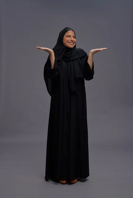 Saudi Woman in Black Abaya Gesturing in Studio