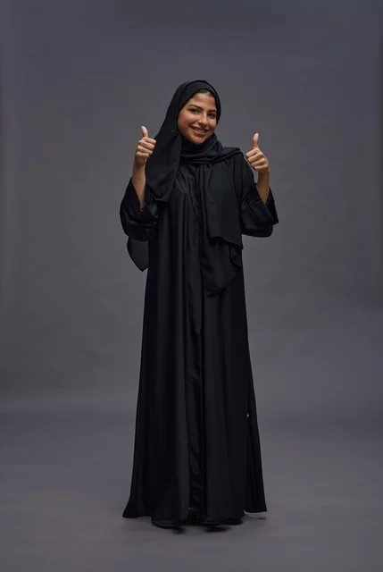 Saudi Woman in Black Abaya Thumbs Up Studio Portrait