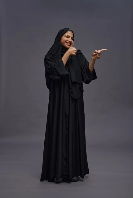 Saudi Woman in Black Abaya Thumbs Up Studio Pose