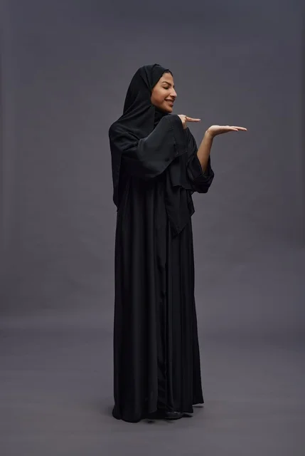 Saudi Woman in Black Abaya Presenting Hand Gesture