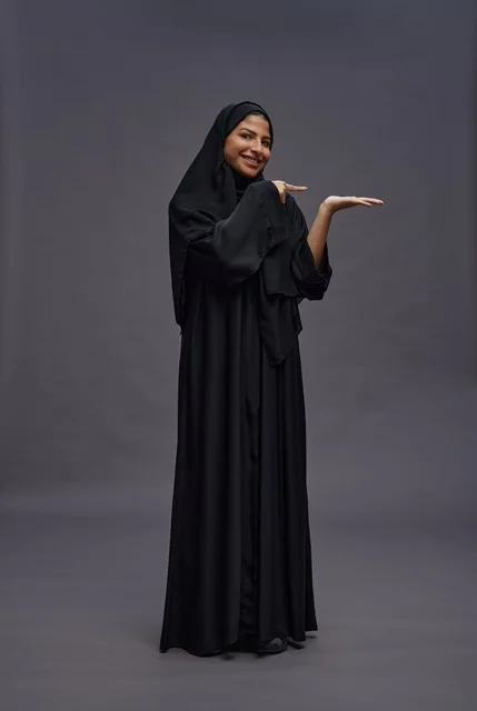 Saudi Woman in Black Abaya with Hand Gesture