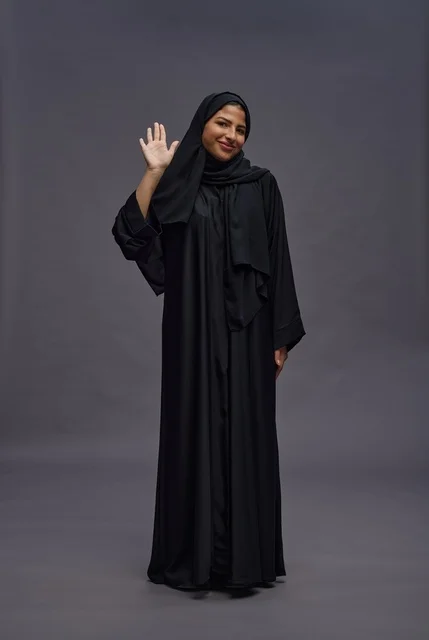 Saudi Woman in Black Abaya Waving in Studio