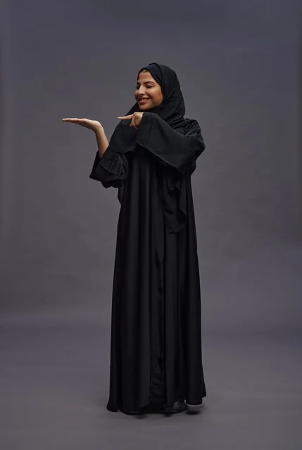 Saudi Woman in Black Abaya Pointing at Hand Studio