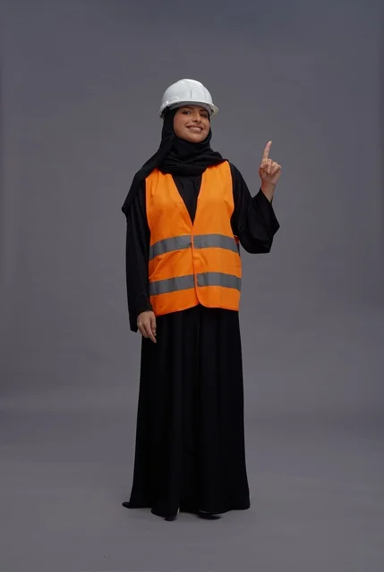 Arab Female Engineer in Safety Gear Pointing Up