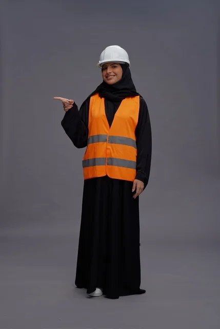 Saudi Woman Engineer Pointing Sideways in Safety Gear