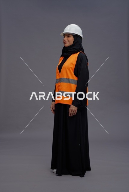 مهندسة سعودية ترتدي سترة السلامة وخوذة العمل