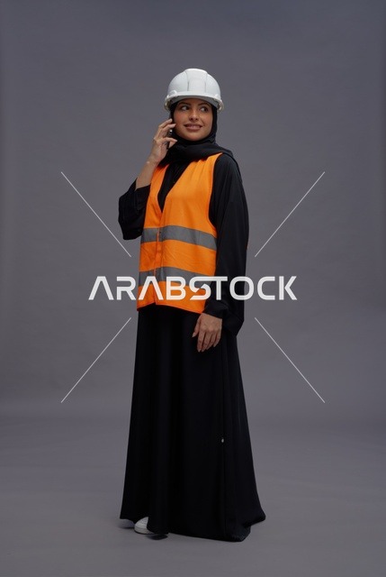 Saudi Female Engineer with Safety Vest and Smartphone