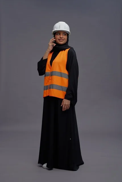 Saudi Female Engineer with Safety Vest and Smartphone
