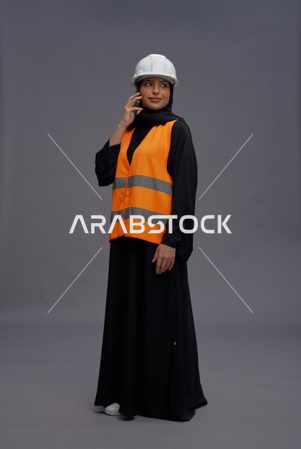 مهندسة سعودية بملابس السلامة تتحدث عبر الهاتف