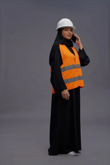 Saudi Female Engineer in Safety Gear with Phone