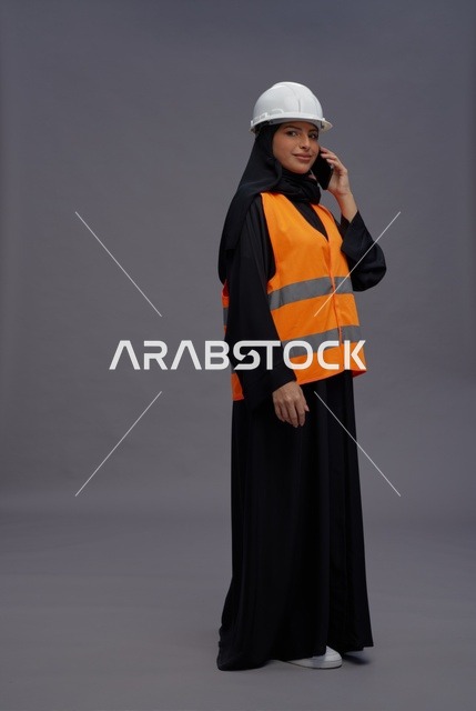 Saudi Female Engineer in Safety Vest on Phone