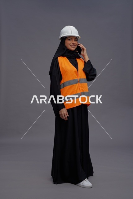 Saudi Female Engineer on Phone with Safety Vest