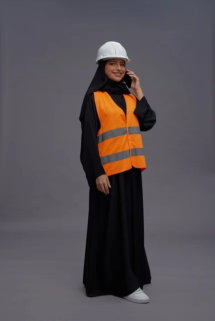 Saudi Female Engineer on Phone with Safety Vest