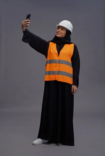 Saudi Female Engineer Taking Smartphone Selfie in Studio