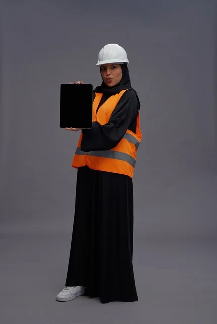 Arab Female Engineer Wearing Safety Vest Holding Tablet
