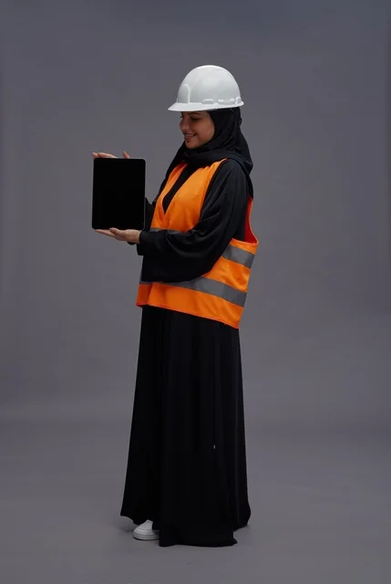 Saudi Female Engineer Holding Tablet with White Hard Hat