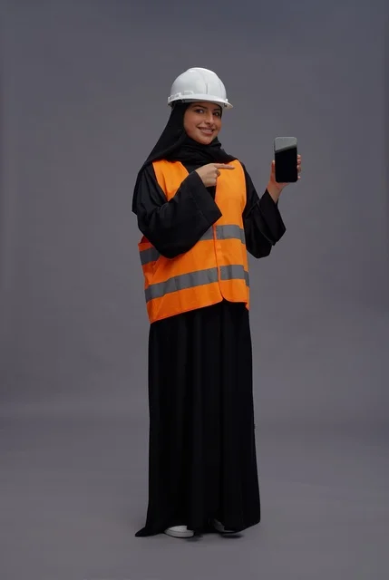 Saudi Female Engineer Pointing at Smartphone