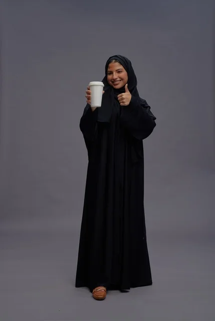 Saudi Woman in Black Abaya Holding Coffee Cup