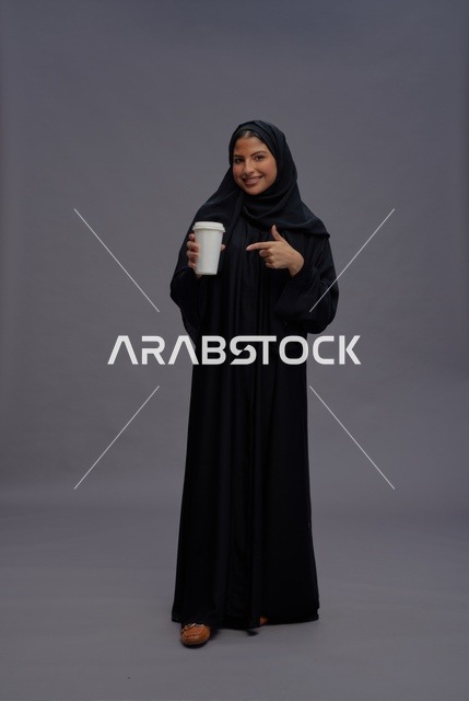 Saudi Woman in Abaya Holding Coffee Cup Studio Shot