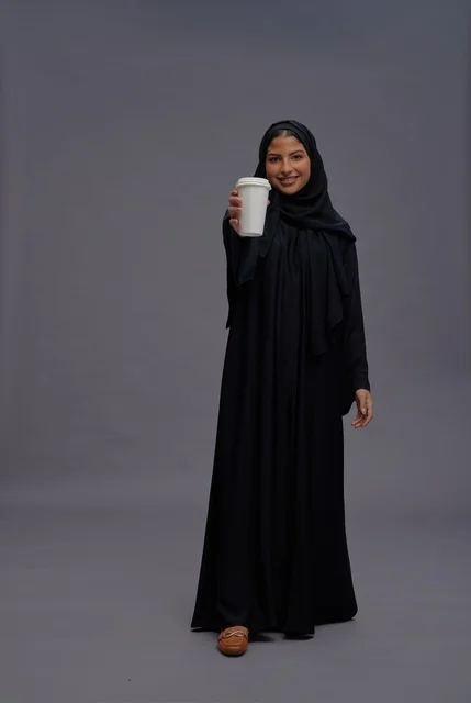 Saudi Woman in Black Abaya Holding Coffee Cup