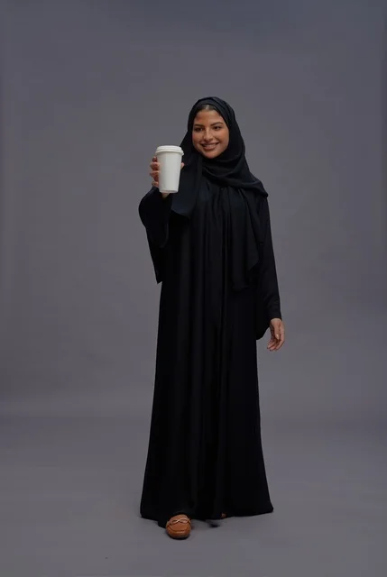 Saudi Woman in Black Abaya Holding Coffee Cup Portrait