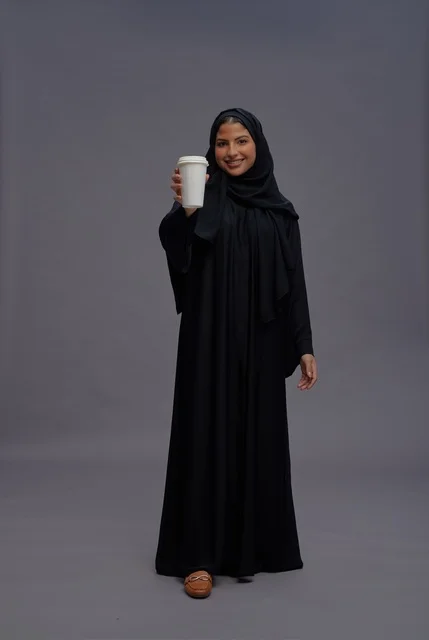 Saudi Woman in Black Abaya Holding Coffee Cup