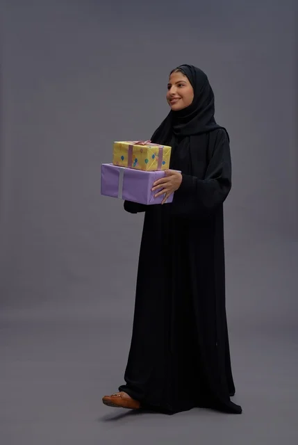 Saudi Woman in Abaya Holding Gift Boxes