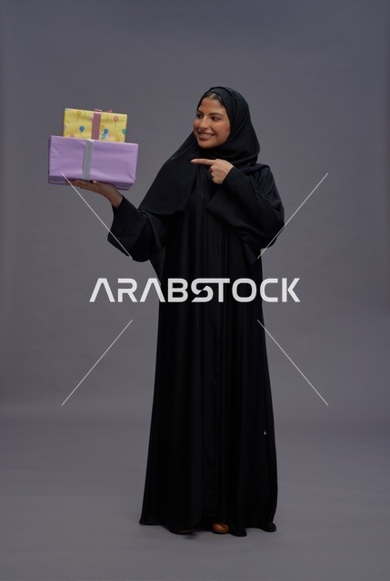 Saudi Woman in Black Abaya Holding Gift Boxes