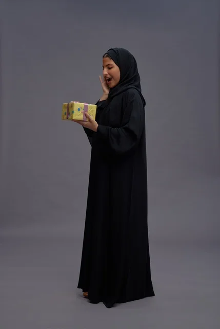 Saudi Woman in Black Abaya Holding a Gift Box Studio