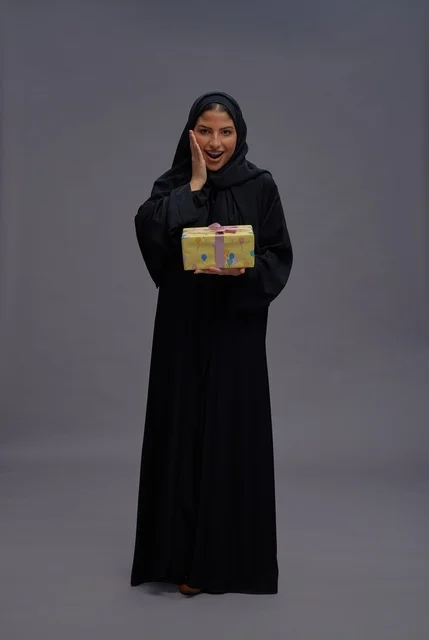 Saudi Woman in Abaya Holding Gift Box Surprise Studio