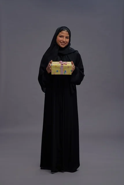 Saudi Woman in Black Abaya Holding a Gift Box