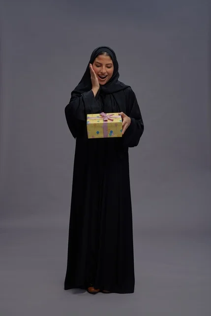 Saudi Woman in Abaya Holding Gift Box