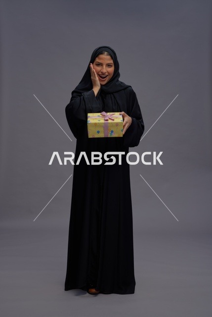 Saudi Woman in Black Abaya Holding a Gift Box