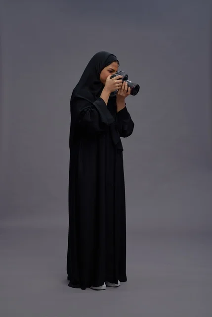 Saudi Woman Photographer in Abaya with DSLR Camera