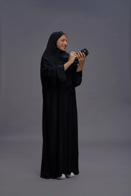 Saudi Woman in Abaya Holding Professional Camera