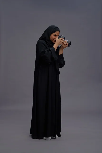 Saudi Woman in Abaya Holding Professional DSLR Camera