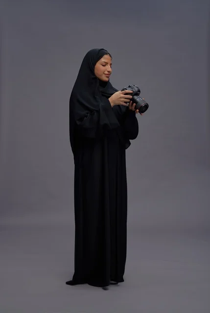 Saudi Woman in Abaya Holding Professional Camera