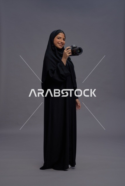 Saudi Woman Photographer with DSLR Camera in Studio
