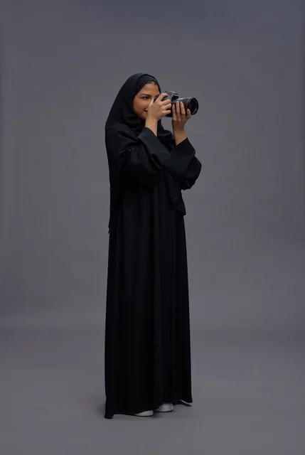 Saudi Woman Photographer with Camera in Studio